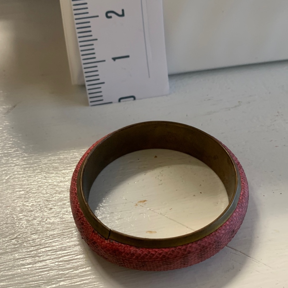 1/2” wide pink snake print leather wrapped metal bangle bracelet.